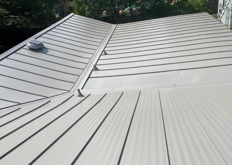 Solar attic fan installed on a metal roof for Roof Ventilation in Burlington